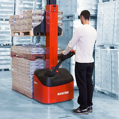 Picture of a Manitou Stacker being operated in a warehouse